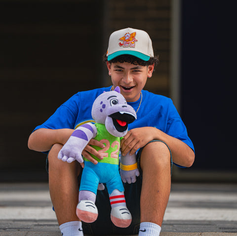 Child holding a colorful plush toy with a blurred background